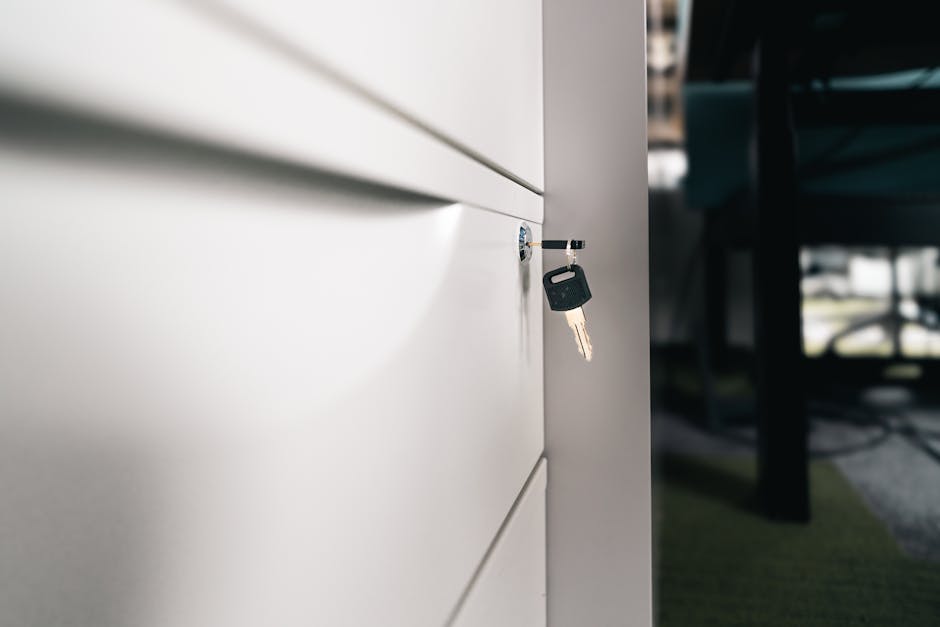Close-up of a key in a locked office drawer for secure storage and privacy.